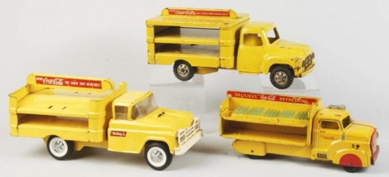 Assorted Coca-Cola Toy Trucks.
