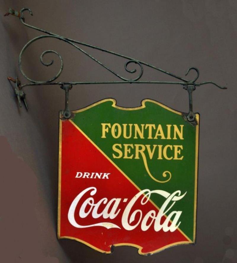Vintage enameled Coca Cola sign on iron bracket