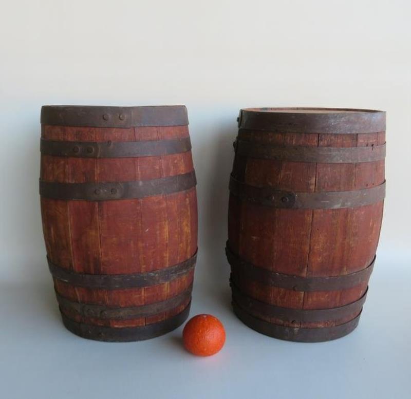 Two primitive wooden barrels in original red stain and